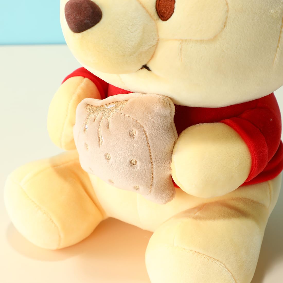 MINISO Winnie-The-Pooh Stuffed Animals Plush Toy Sitting Holding Biscuits, Soft Cute Ideal Gift Doll for Sleeping and Decoration